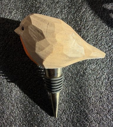 Robin Bottle Stopper A wooden bird-shaped wine stopper with a plated metal base.